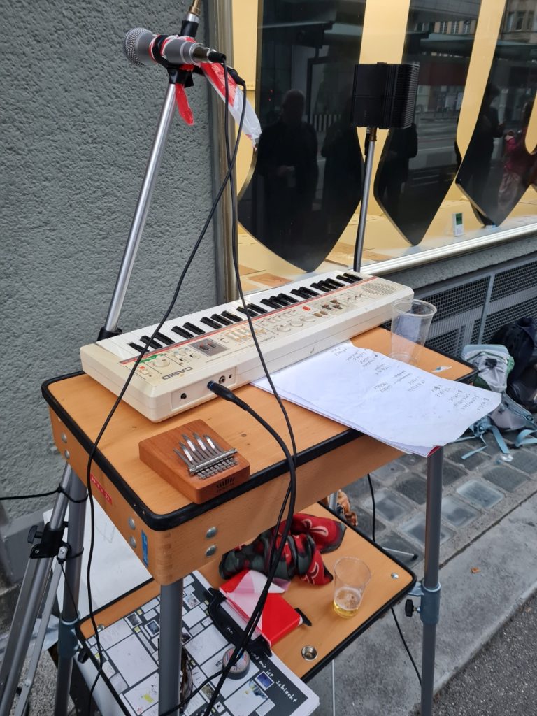 composition of presentation furniture case, casio keyboard, micro stand, micro, barrier tape and kalimba.